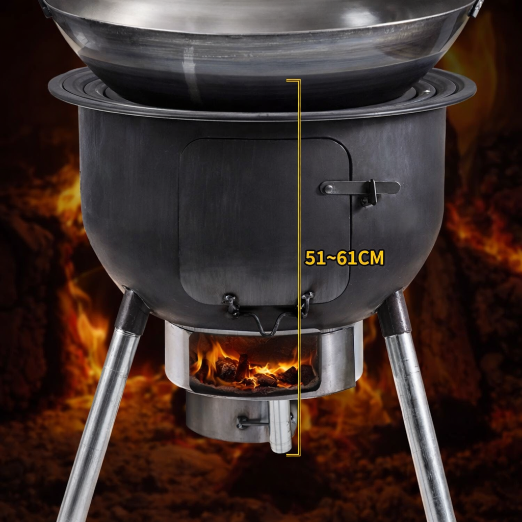 Black portable stove with a frying pan on top, burning wood in the background